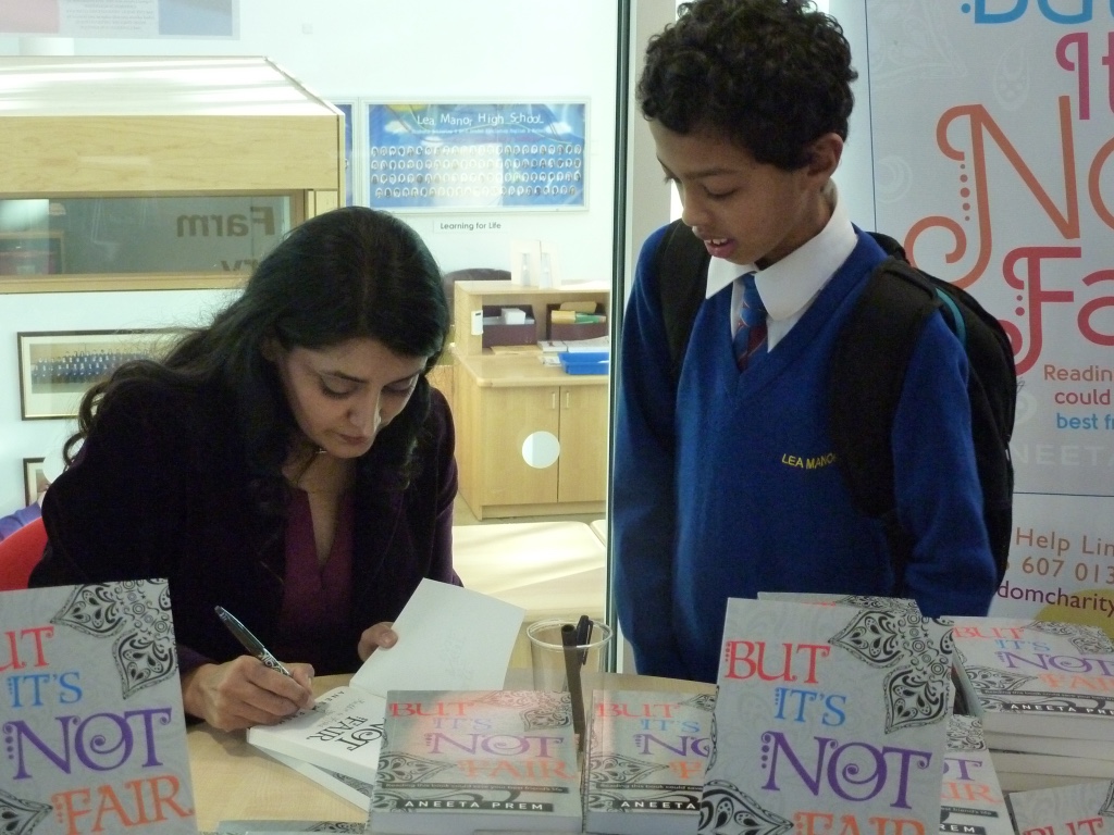 A young reader watching Aneeta Prem sign But It's Not Fair